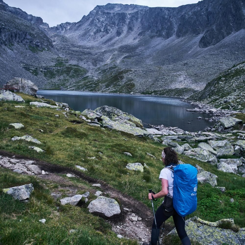Female hiker on a scenic alpine trail in Mittersill, Austria.